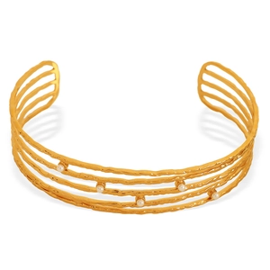 Golden multi-layer wavy open cuff bracelet with small white pearls on a white background