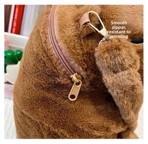 Detail of a smooth metal zipper and soft brown plush texture on Capybara backpack