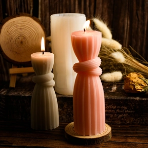 Detail of ribbed knot pillar candles in pink and white with DIY silicone mold