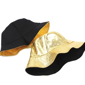 Reversible bucket hat in metallic gold and matte black finish with stitched brim