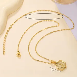 Detailed view of golden hexagonal initial J pendant with 45+5cm adjustable chain and lobster clasp