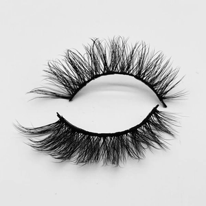 Detailed view of black thick faux mink eyelashes with natural curl on white background