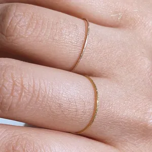 Macro shot of ultra-thin frosted gold and rose gold rings with matte sandblasted texture