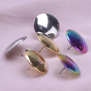 Detailed view of round stainless steel stud earrings in silver, gold, rose gold, and rainbow