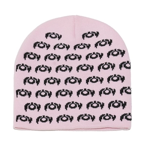 Close-up of the pink knit beanie featuring detailed black jacquard patterns and soft texture