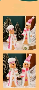 Close-up of knit gingerbread man figures with sequins and plush scarves for Christmas decor