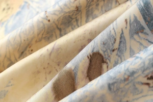 Gros plan détaillé du tissu en satin soyeux avec des motifs abstraits bleu et brun