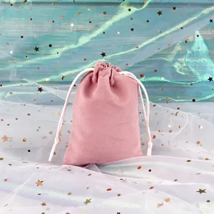 Detailed texture of pink velvet drawstring pouch with soft fabric and braided rope