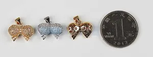 Micro-pave bow jewelry charms in gold and silver finish with coin for size reference