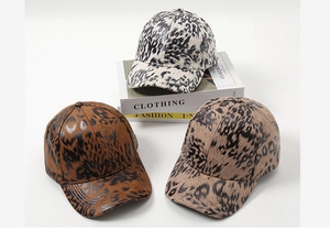 Three leopard print baseball caps in beige, dark brown and light tan colors