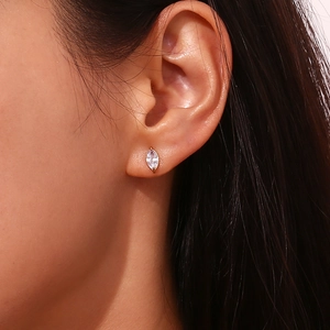 Close-up of 18K gold-plated marquise zircon stud earring worn on ear