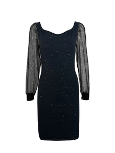 Detailed view of black bodycon evening dress with sheer mesh sleeves and silver sequins