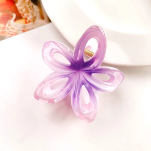 Detailed close-up of hollow plumeria hair claw with purple gradient marble texture