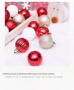 Detailed view of red, white, and gold Christmas ornaments with glitter and matte finishes