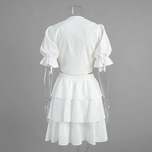 Rear view of white two-piece set featuring puff sleeves and a tiered cake skirt