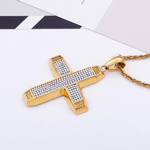 Detailed close-up of 18K gold plated cross pendant with iced out cubic zirconia