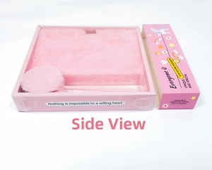 Side view of pink plush notebook stationery set with a furry pom-pom pen in gift box