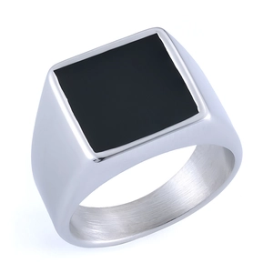 Macro view of signet ring showing square black stone inlay and brushed metal interior