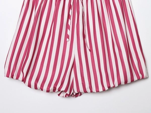 Detailed close-up of red and white vertical stripe shorts with drawstring waistband