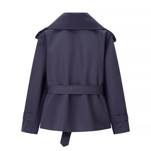 Detail of dark blue cropped jacket with waist belt, epaulets and sleeve cuff straps