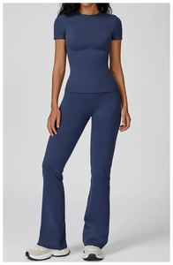 Slim fit dark blue yoga set with short sleeve top and flared leggings on model