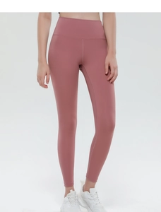 Detail of high waisted yoga leggings in mauve with a tummy control wide waistband