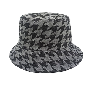 Close-up of the black and gray houndstooth texture and woven fabric on the bucket hat