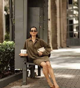 Close-up of olive green faux suede knee-length skirt with elegant commuter style detail