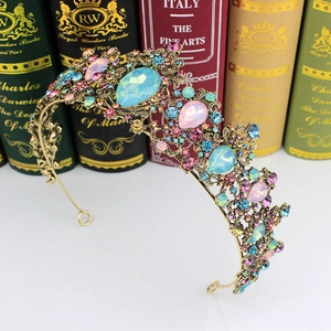 Detailed close-up of vintage gold bridal crown featuring colorful rhinestones and jewels
