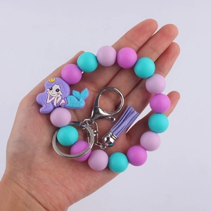 Cartoon mermaid silicone beaded wristlet keychain with purple tassel on white background
