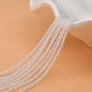 Macro detail of 2mm faceted transparent crystal beads with iridescent finish for jewelry