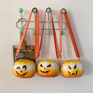 Detailed view of three Jack-o'-lantern pumpkin cross-body bags with unique expressions