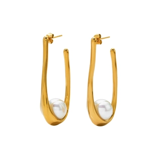 Elegant gold U-shaped earrings with large white pearls on a clean white background