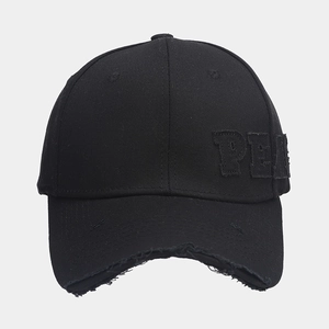 Detail view of distressed brim and PE embroidery on black cotton baseball cap