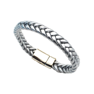 Dettaglio macro di un bracciale intrecciato grigio da uomo con chiusura magnetica in oro lucido