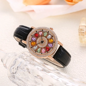 Detail of rose gold watch with rhinestone bezel and colorful gemstone flower dial