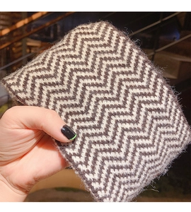 Macro shot of knitted mohair headband showing brown and white wave pattern and fuzzy texture