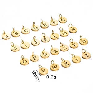 Detailed set of 26 golden 12mm stainless steel hollow alphabet charms on white background