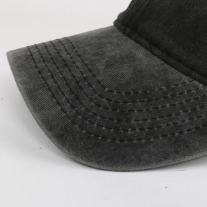 Detailed close-up of dark grey washed cotton baseball cap brim with durable stitching