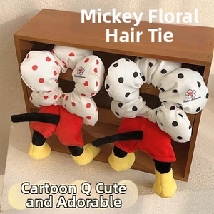 Close-up of cute polka dot scrunchies with character shoes and shorts decor in a box