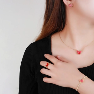 Elegant gold-tone butterfly jewelry set with red butterfly necklace, earrings, and ring