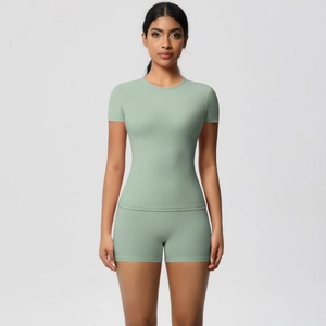 Close-up of light green skin-friendly yoga set with slim fit T-shirt and tight shorts
