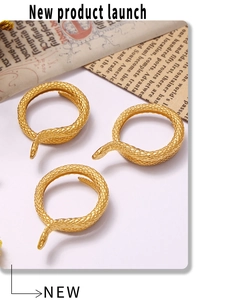 Macro shot of 18K gold plated snake rings with intricate scale textures and retro design