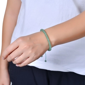 Adjustable natural green stone bead bracelet with handmade woven cord on model wrist