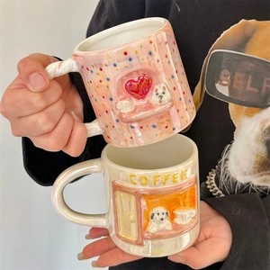 Detail of pink polka dot and pearlescent white relief puppy ceramic coffee mugs