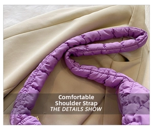Detail of light purple quilted shoulder strap with soft puffy nylon fabric texture