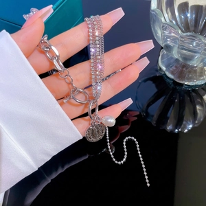 Silver multi-layer chain bracelet featuring pearls and vintage coin pendants