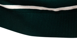 Close-up of dark green ribbed knit sweater texture with white stripe detail