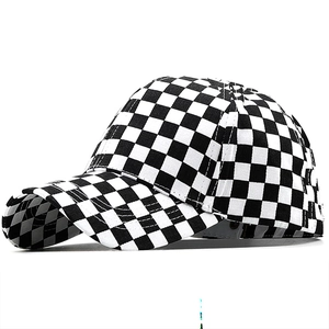 Detail view of the black and white checkerboard pattern on the baseball cap crown