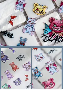 Detailed macro of 5D embossed nail stickers featuring evil bear and skull motifs